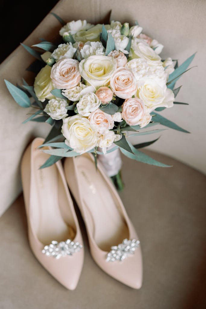 A beautiful bouquet of roses and bridal shoes perfect for a wedding day.